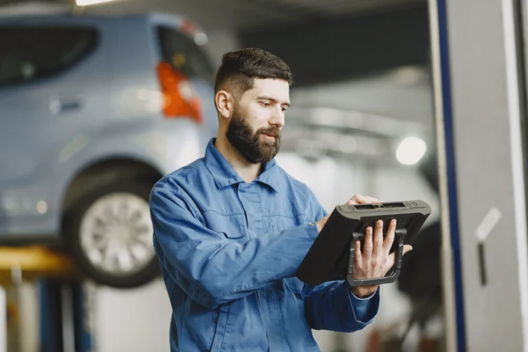 car-mechanic-with-tablet-near-car-work-clothes