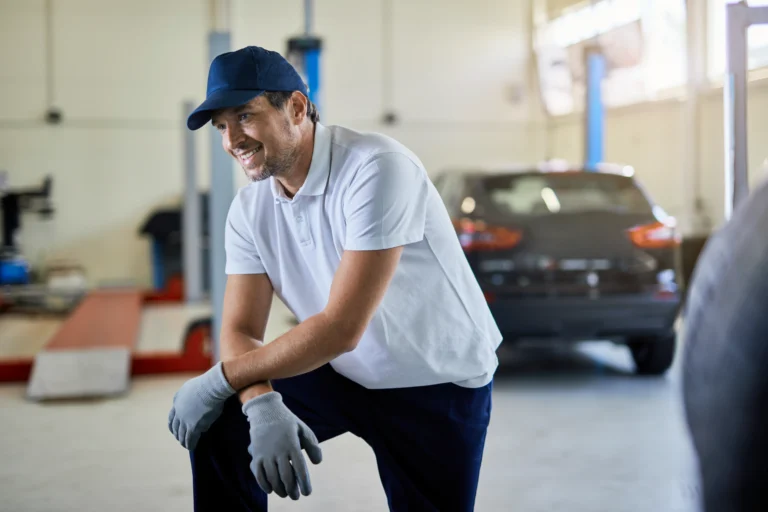 happy-car-mechanic-resting-while-working-auto-repair-shop